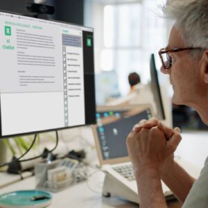 Man focused on computer screen, working intently.