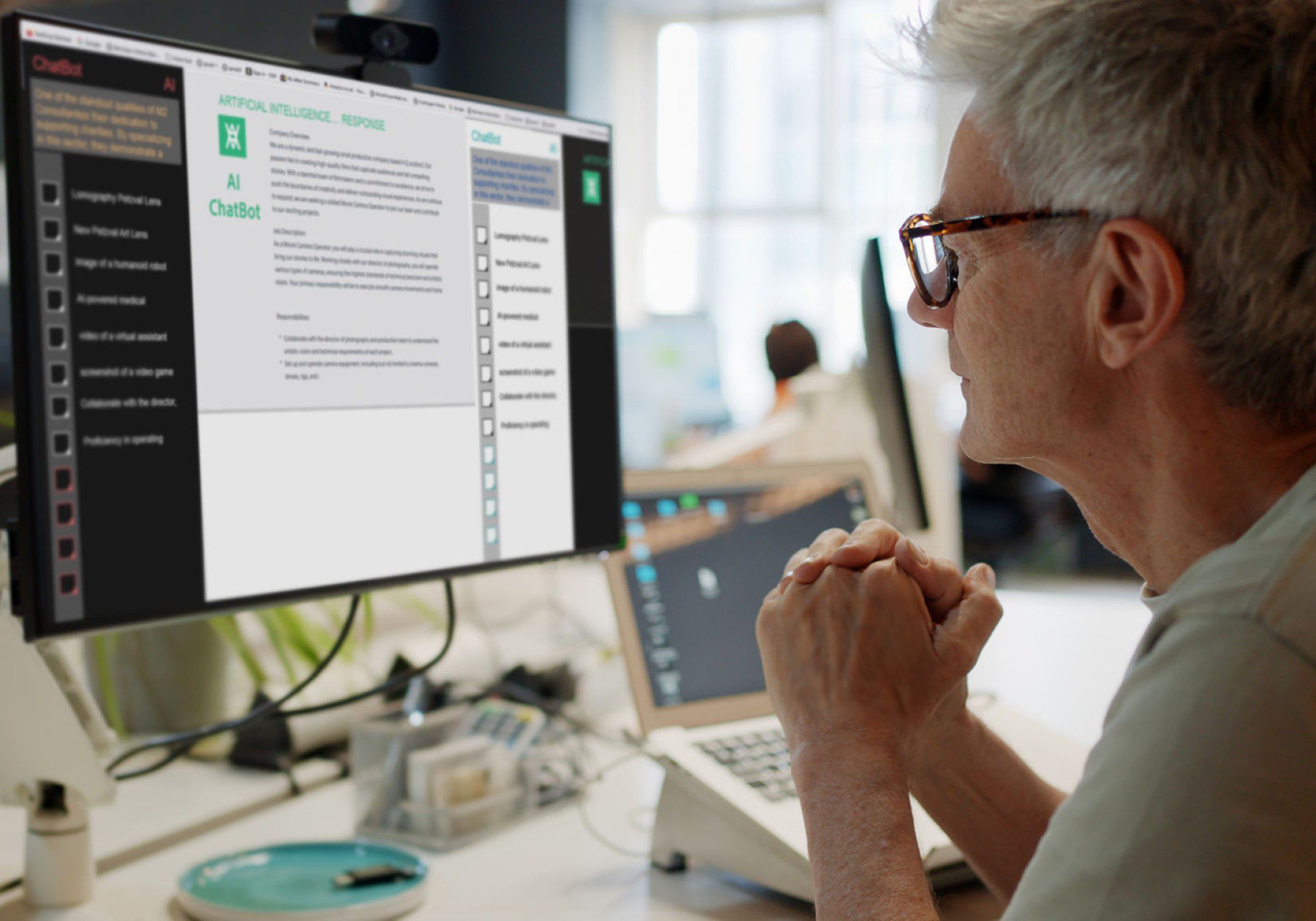Man focused on computer screen, working intently.