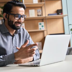 Man video conferencing on a laptop.