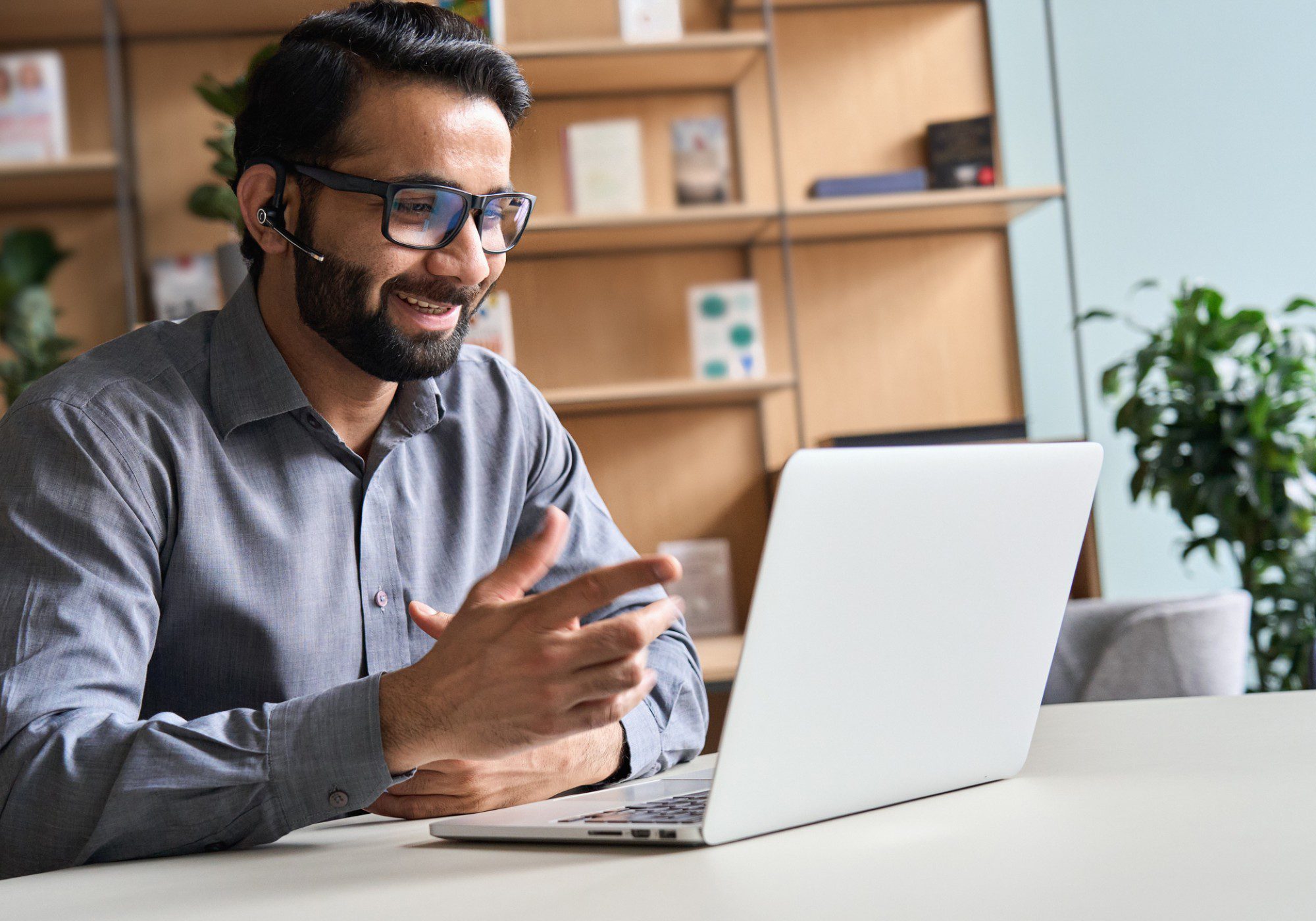 Man video conferencing on a laptop.