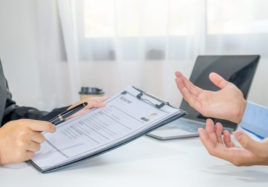 Job interview with resume on table.